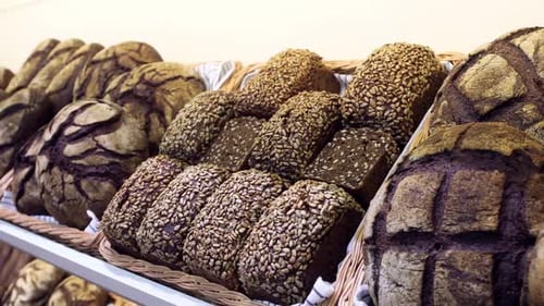 Selection of Dark Bread Loaves in Bakery Display