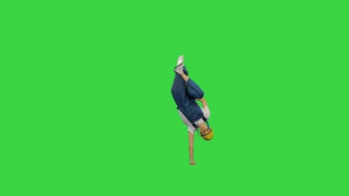 Young Adult Breakdancing in Overalls on Green Screen