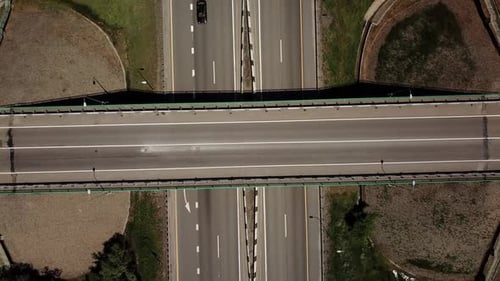 Top Down Zoom Out View of Highway Intersection Car Bridge and Moving Cars