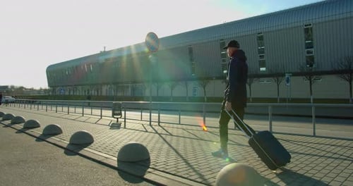 The Guy with the Suitcase Is Heading To the Airport. Travel By Plane. Sunny Weather