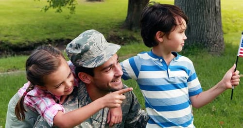 Soldier Poses with Children and American Flag