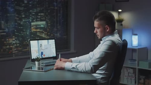 Man at Desk Having an Online Video Call