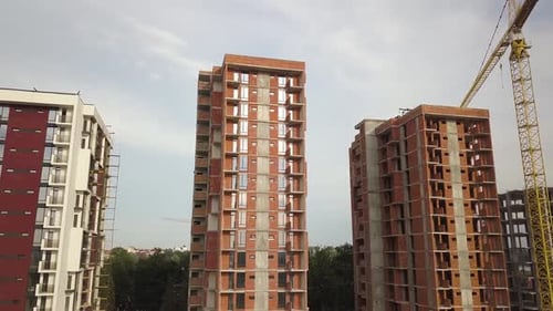 Aerial view of tall residential apartment buildings under construction. Real estate development.