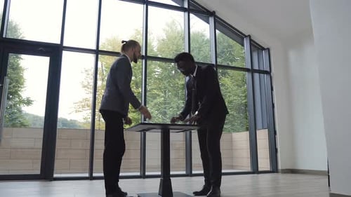 Shaking Hands During a Meeting and Signing of Successful Business Contract at the Office