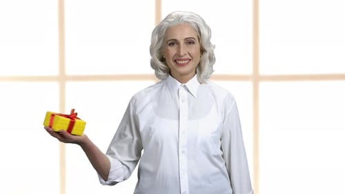 Senior Woman Presents a Gift