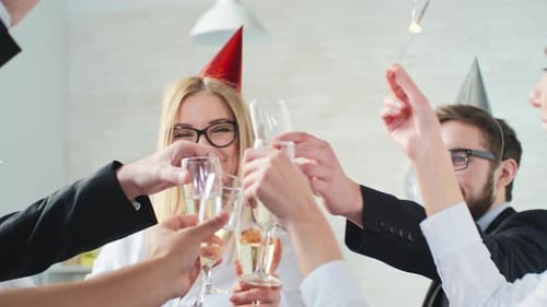 Cheerful Colleagues Celebrating with Champagne and Sparklers