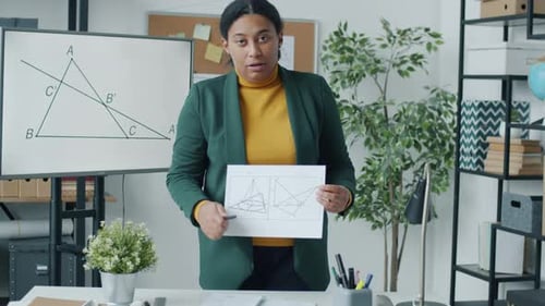 College Teacher Working Online Because of Covid19 Quarantine Teaching Maths and Looking at Camera