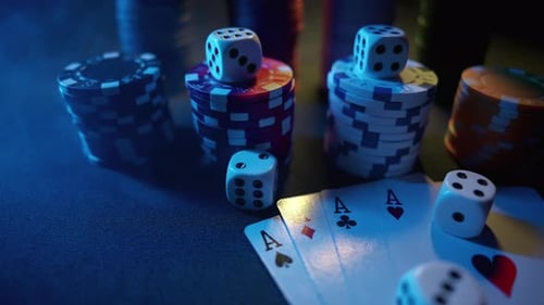 Casino Chips with Dice and Playing Cards on a Dark Table