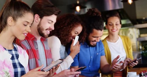 Friends Using Phones in Urban Indoor Setting