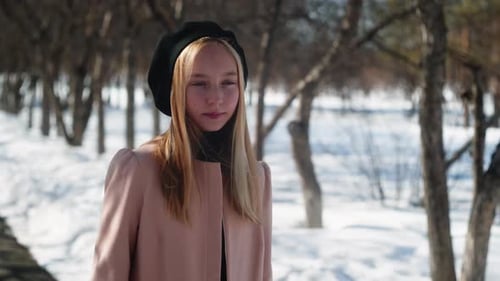 Fashionable Female Model in Beret and Elegant Coat in Winter Park