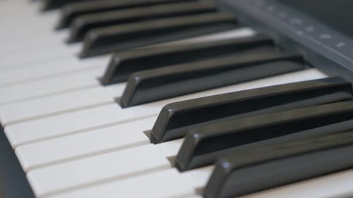 Electric piano keys close-up panning 4K 2160p UHD footage - Electric piano black and white keyboard