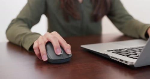 Woman Using Mouse and Laptop on Desk