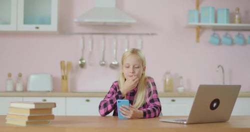 School Preteen Girl Using Mobile Phone Application for Watching Popular Video Online. Kid Stays at