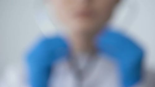 Close Up of Stethoscope in Blue Gloved Hand