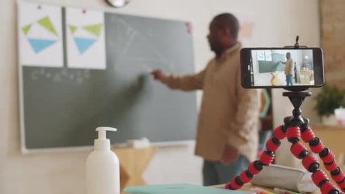Black School Teacher Giving Online Class via Web Call on Smartphone