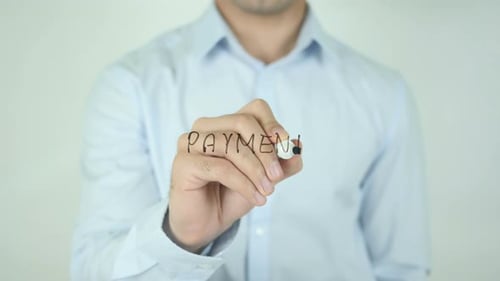 Man Writes Word Payment on Clear Surface