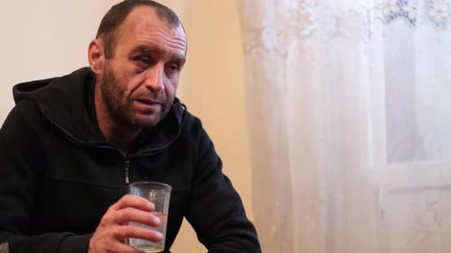 A Young Man with a Blind Eye Suffers From Alcoholism