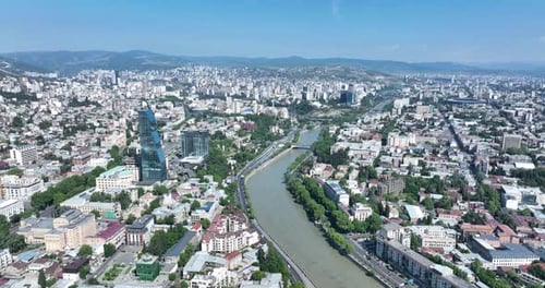 Tbilisi, Georgia - June 7 2022: Flying over kura river in the center of Tbilisi city