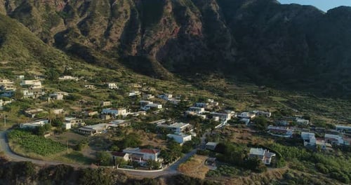 Panoramic and Picturesque Rocky Coastline During Sunset with Green Fields Trees and Small Village