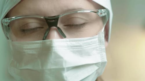 Female Doctor Wearing Protective Safety Equipment and Mask