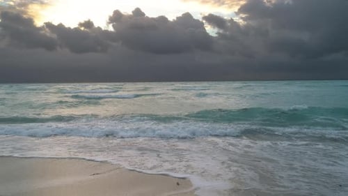 Ocean Waves Crashing On Beach At Sunrise Or Sunset Moody Clouds