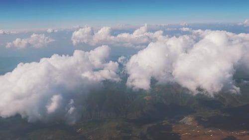 Aerial View of Clouds over Green Mountains