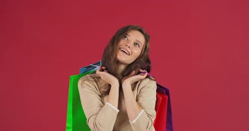 Smiling Woman Posing With Colorful Shopping Bags