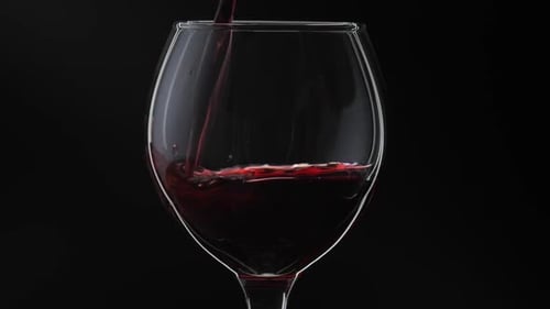 Red Wine Being Poured Into Glass
