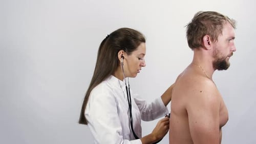 Doctor Listens to Man's Back with Stethoscope