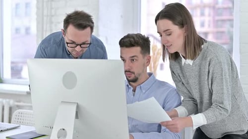 Close Up of Creative Startup Team Working Together on Desktop