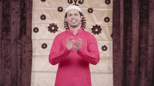 Happy Muslim man clapping