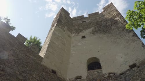 A Close Up View of a Tower From a Bottom of an Old, Historical Castle on a Bright Sunny Day.