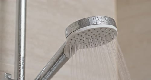 Close Up of Shower Head with Flowing Water
