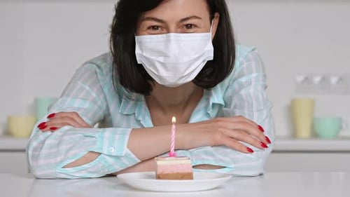 Woman Celebrates Birthday with Cake and Candle