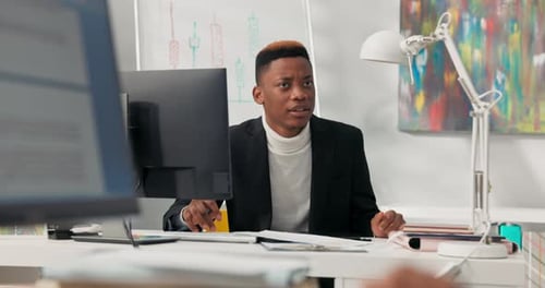 Young Man Working at Desk in Office