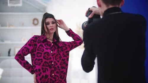Young Beautiful Model Woman in Pink Leopard Suit Having Photoshoot in White Studio