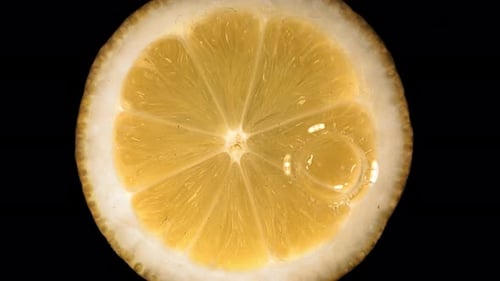 Super Slow Motion of Falling Water Drop on Lemon Slice