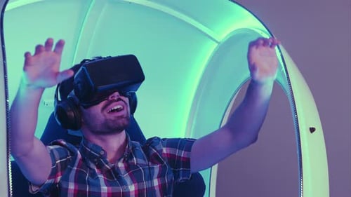 Man Experiencing Virtual Reality in Futuristic Pod