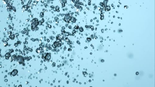 Abstract Water Stream and Splashes on Light Blue