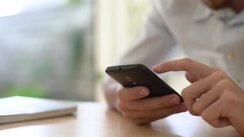 Person Using Smartphone Inside Home, Close Up
