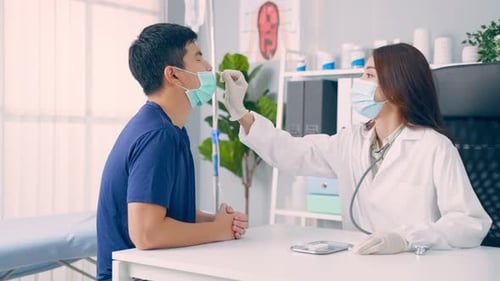 Doctor Takes Nasal Swab from Male Patient in Office