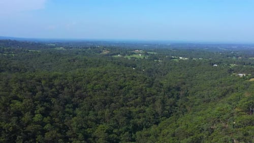 Aerial shot of an epic scene of rural Sydney Australia, Houses and green tree dense hilly forest on