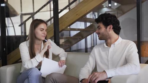 Young Woman Interviews Man in Modern Office