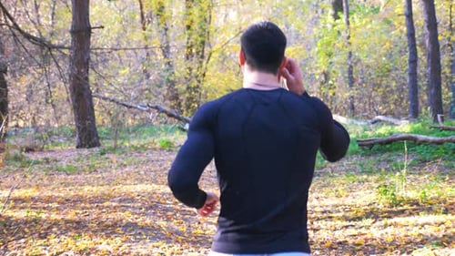 Unrecognizable Man Running Along Forest Path