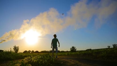 Child Runs and Throws Paper Airplane at Sunset