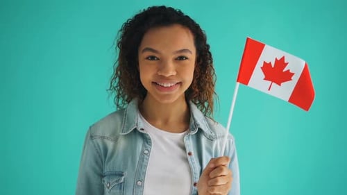 Smiling Young Adult Holding Canadian Flag
