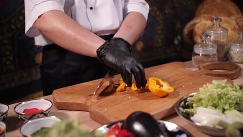 Close Up of Chef Slicing Yellow Bell Pepper