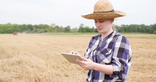Woman Farmer Using Tablet in Wheat Field