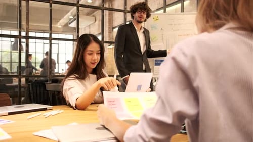 Collaborative Team Meeting Presentation in a Modern Office