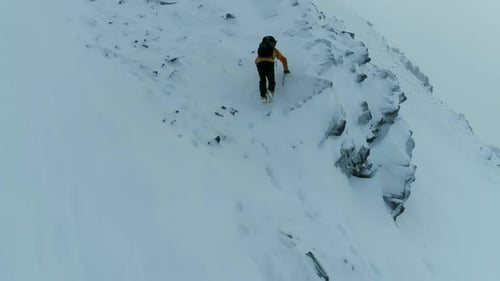 Mountain Climber Ascending a Difficult Rock Face